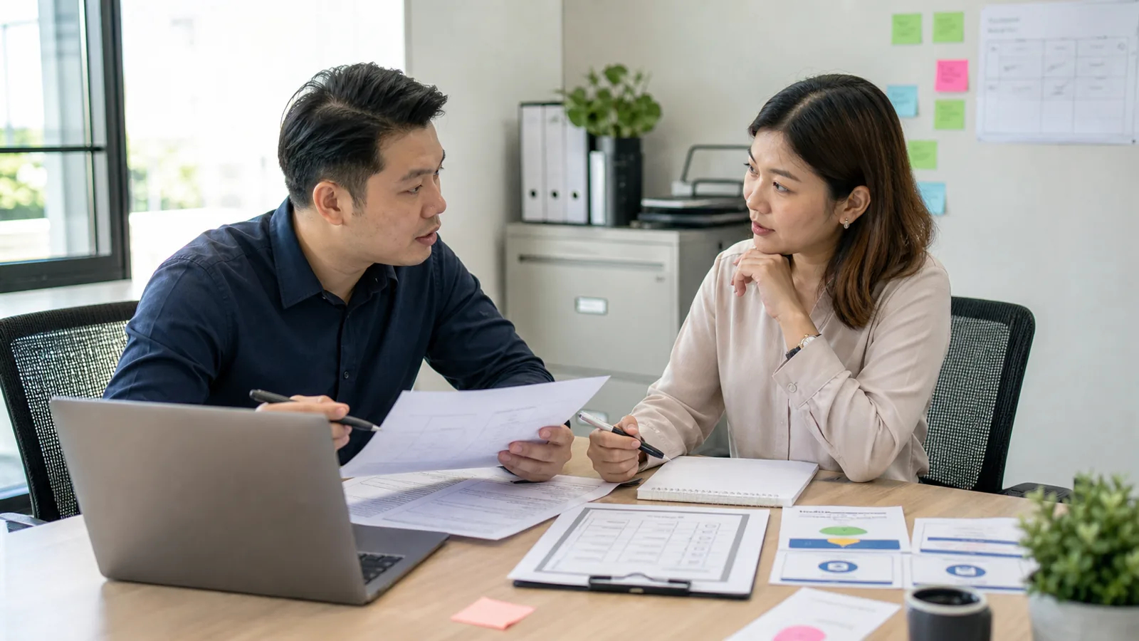 A Singapore SME manager and data-protection colleague review a customer-question data workflow.