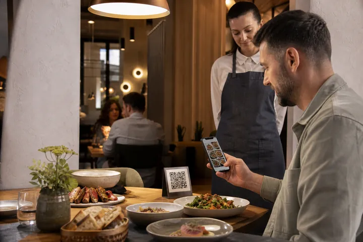 A restaurant guest scanning a table QR code and browsing a visual food menu on a phone